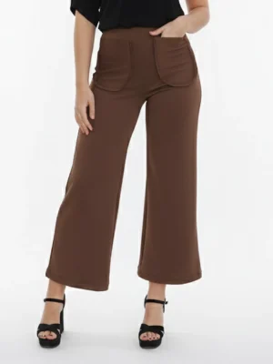 Pantalón marrón chocolate confeccionado en tejido de neopreno, con dos pequeñas aberturas en el bajo y bolsillos delanteros. Una prenda cómoda y elegante, ideal para crear looks actuales y versátiles.