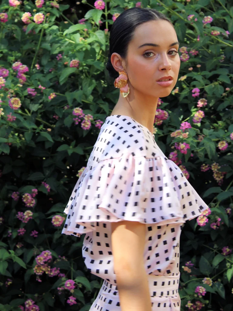 Blusa rosa estampada con volante Miranda. Diseño femenino con tejido satinado y volantes en hombros. Ideal para invitadas, oficina y eventos especiales.